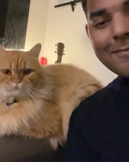 Siddhant at home with his cat
